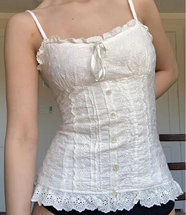 White lace camisole worn by a person indoors.