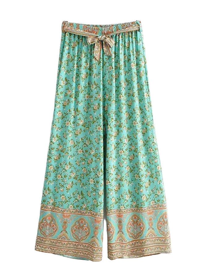 Turquoise floral-patterned pants with a decorative waistband on a white background